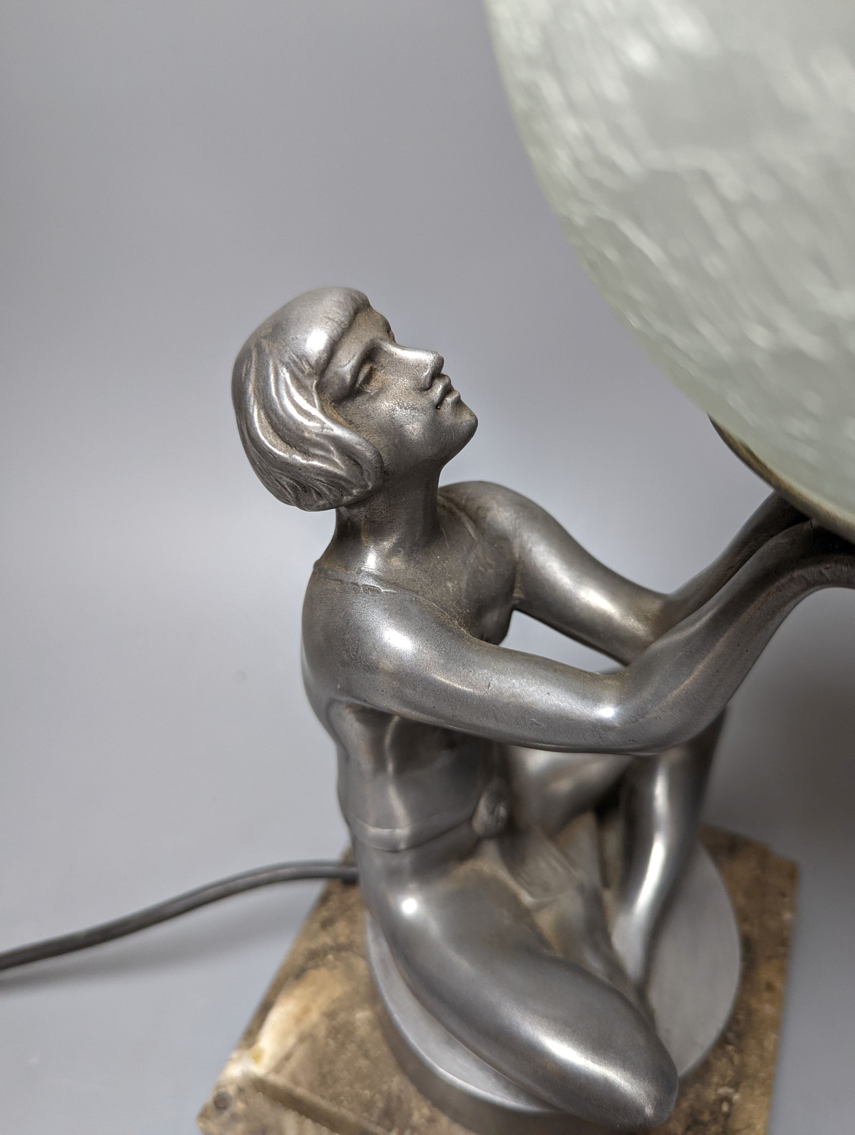 An Art Deco style ‘seated female’ lamp with spherical shade and marble base. 37cm